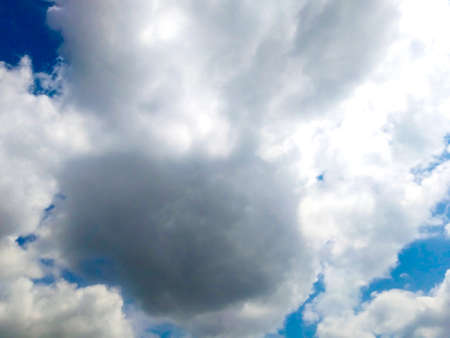 Bright blue sky background with cloudsの写真素材