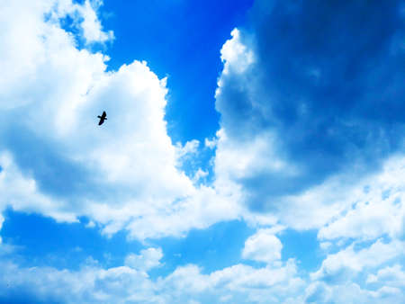Bright blue sky background with cloudsの写真素材
