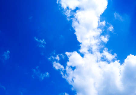 Bright blue sky background with cloudsの写真素材