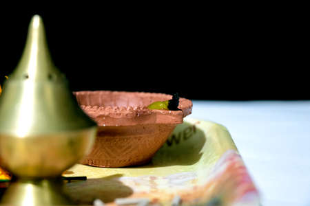 Happy Diwali. Clay diya candle illuminated in Dipavali, Hindu festival of lights. Traditional oil lamp on dark backgroundの写真素材