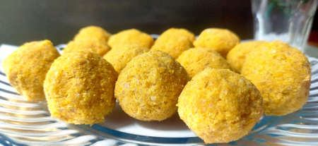 A mouth watering sweet - Besan laddoo made by roasted gram flour, ghee, dry fruits and sugar, served in a plateの写真素材