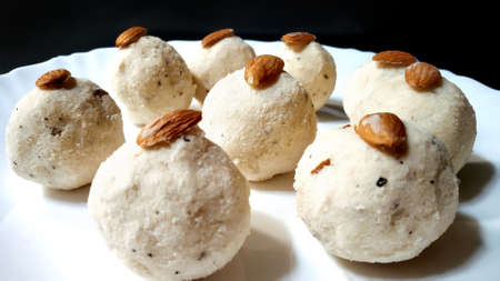 Tasty rice Laddus in white plate garnished with dry fruits in indiaの写真素材