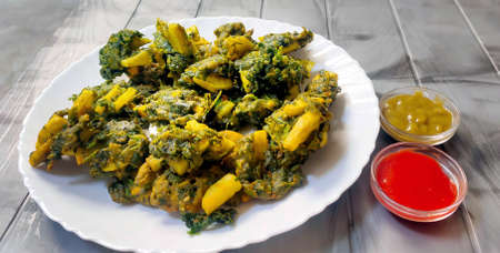 Spinach & potato Pakoras with sauce, An extremely delicious and mouth watering snack of Pakistani & Indian Peoplesの写真素材
