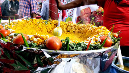 Lucknow, uttar pradesh - january 2021 : Man making Aloo tikki (fried potato cutlets), food stall...