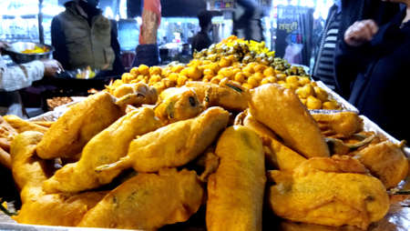 Lucknow, uttar pradesh - january 2021 : A street food seller fries snacks pakodas for sale inのeditorial素材