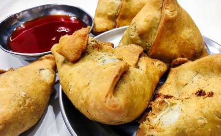 Potato samosa on white background, Traditional indian or pakistani ramadan food, Spicy street food, Famous snacks in asian country.の写真素材