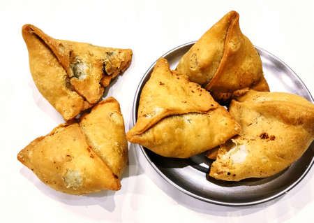 Potato samosa on white background, Traditional indian or pakistani ramadan food, Spicy street food,...