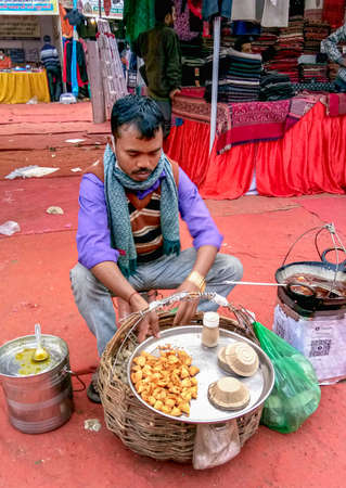 Lucknow, India, January 2021 : A man selling samosas at the fair in lucknowのeditorial素材