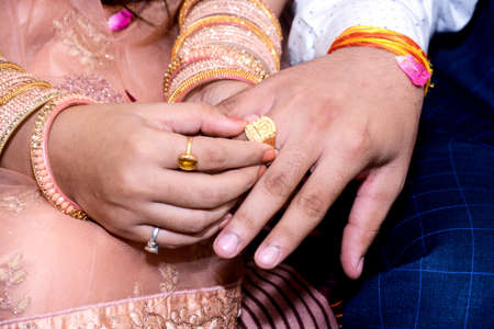 Wearing a ring at the engagement ceremony in india