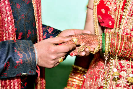 Wearing a ring at the engagement ceremony in indiaの写真素材