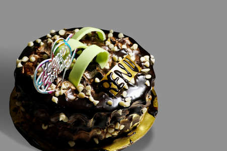 A tasty decorated Birthday Chocolate Cake with Cream and Nuts on the tableの写真素材