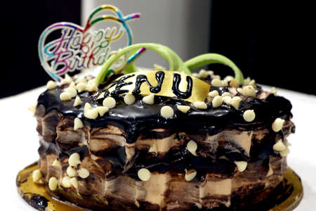 A tasty decorated Birthday Chocolate Cake with Cream and Nuts on the tableの写真素材