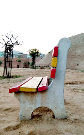 An empty cemented bench in the park