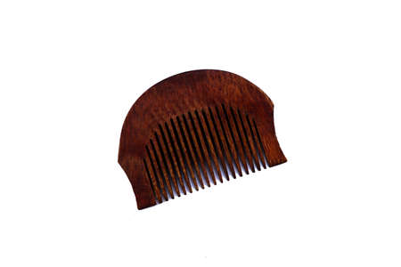 A wooden comb for hair and beard isolated on white backgroundの写真素材