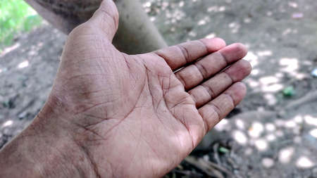 Giving a helping hand, asking or offering help close-up shot of a asian man in india