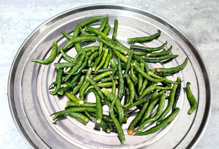 A close up top view of freshly harvested green chilliesの写真素材