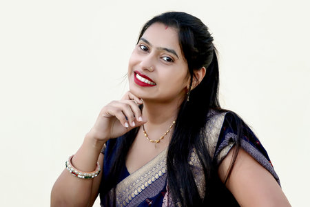 A portrait of an Indian happy woman wearing traditional dress sari in white background. Selective...