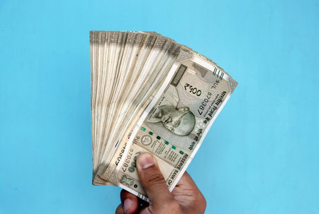 A Man Hand holding Rupees 500 bank note savingsの写真素材