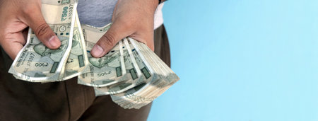 A Man counting 500 rupee banknotesの写真素材