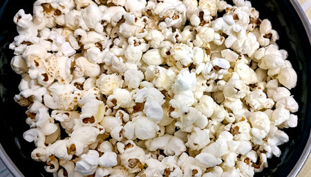Closeup view of bowl of popcorn on a wooden tableの写真素材