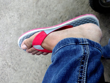 Feet of Indian man wearing slippers on the Concrete Floor Great For Any Useの写真素材