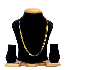 Necklace display stand with gold necklace isolated on white background with copy space for textの写真素材