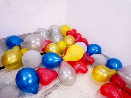 lot of coloured baloons on the floor, ready for party or birthdayの写真素材