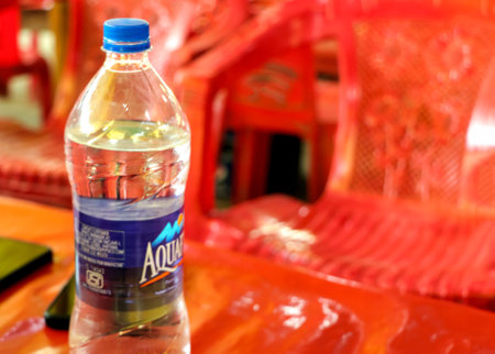 New Delhi, India, December 2 2021: plastic bottle of drinking water on a table, taken at an outdoor cafe in Indiaのeditorial素材