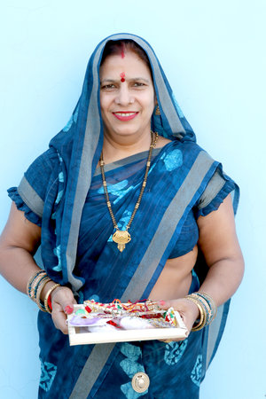 Indian woman performing worship, portrait of a beautiful lady with pooja thali in India