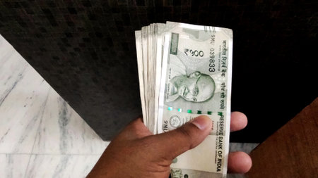 A Man Hand holding Rupees 500 bank note savings