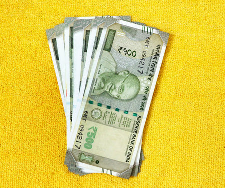 A closup of fanned out spread out Indian Rupees currency paper notes
