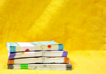 Bundles of 50, 100, 200 or 500 rupee notes arranged in a rowの写真素材