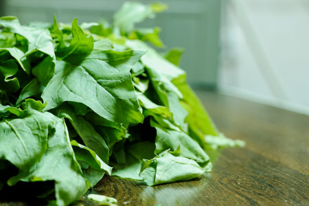 Close-up shot of fresh green spinach leaves, commonly known as palak in India. Ideal for food,...