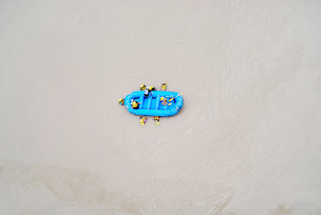 An exhilarating scene of river rafting adventure in Rishikesh, India, showing participants floating...