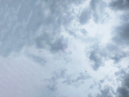 A scenic view of fluffy cumulus clouds against a bright blue sky. Ideal for backgrounds, weather concepts, and nature themes.の写真素材