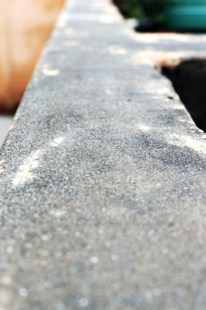 Close-up view of a rough concrete surface with shallow depth of field, suitable for background or texture use.の写真素材