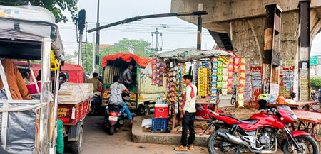 Lucknow, Uttar Pradesh, India, 29 June 2024: Traffic congestion with motorcycles, small trucks, and...