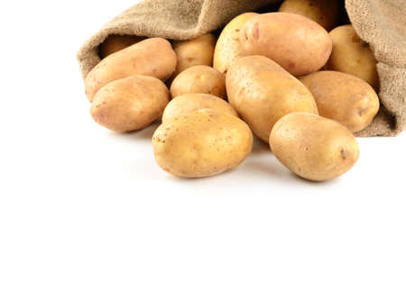 Potatoes in bag solated on whiteの写真素材