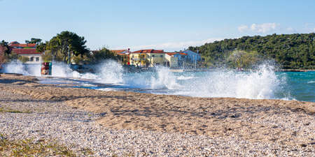 Shore break explosion on a windy day at the quiet public beach.