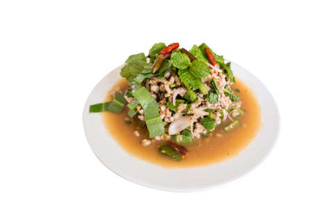 Thai spicy minced pork laab salad served on a white plateの写真素材