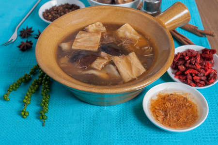Double boiled pork rids, black mushroom in chinese herb soup menu with decoration and backgroundの写真素材