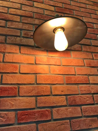 warm light with brick wall backgroundの写真素材