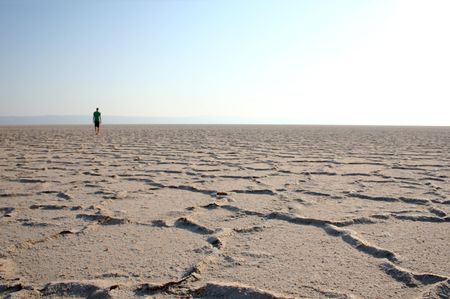 young man walking in the desertの写真素材