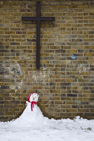 A little snowman under a church cross の写真素材