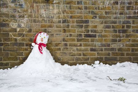 A little snowman under a church cross の写真素材
