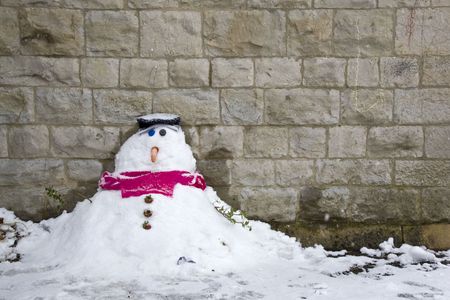A little snowman under a church cross の写真素材