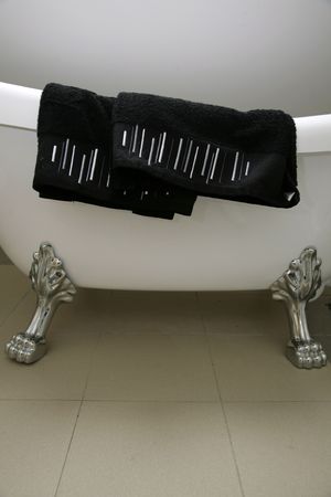 a roundtop bath with lions feet and towel.の写真素材