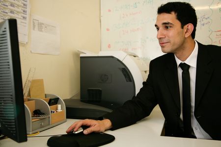 a worker in his office surfs the netの写真素材
