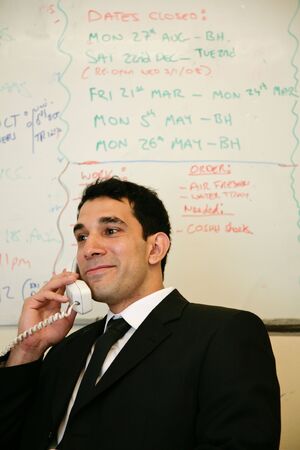 an asian businessman answers the phoneの写真素材