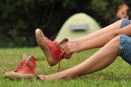 Girl puts her walking shoes onの写真素材